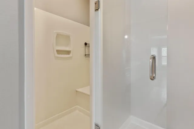 a view of an empty room and a fireplace