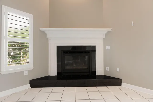 a kitchen with granite countertop white cabinets and black appliances