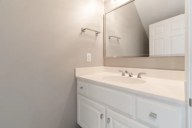 a bathroom with a double vanity sink a mirror and a shower