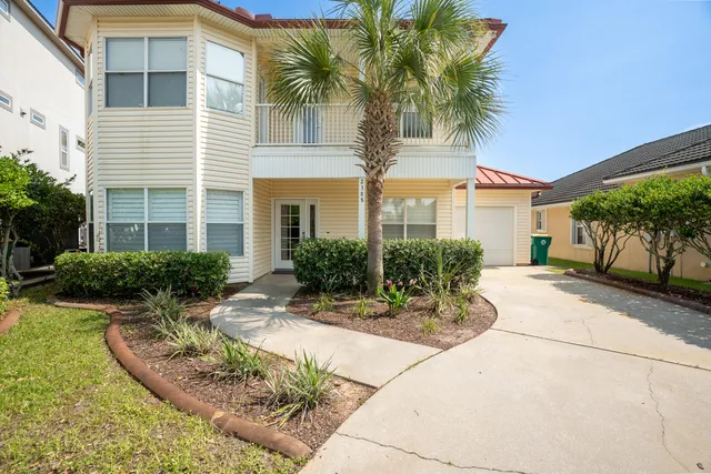 a front view of a house with garden