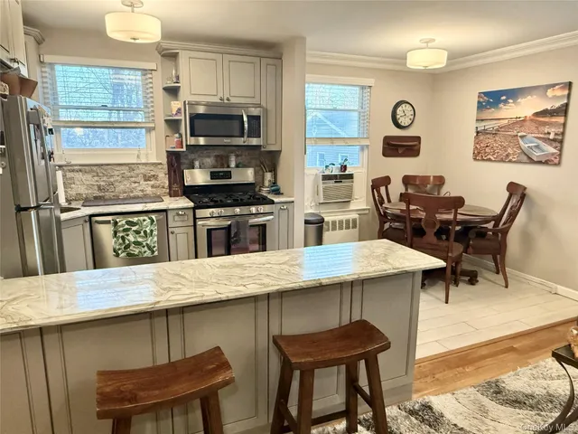 a kitchen with a table chairs and a refrigerator