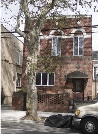 a front view of a building with parking space