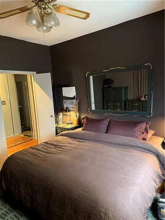 a bedroom with a bed and a mirror