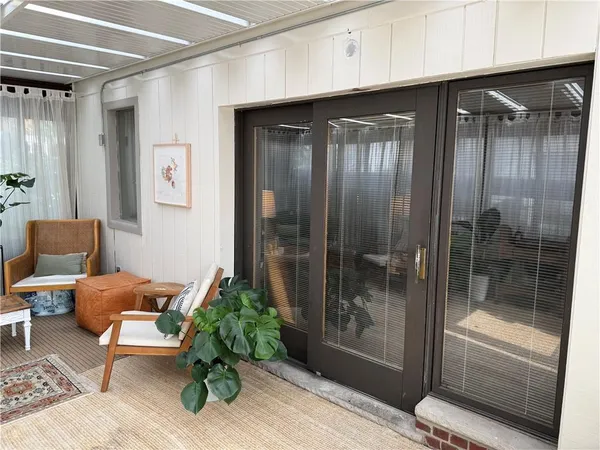 a view of a hallway with furniture and a potted plant