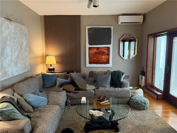 a living room with furniture rug and window