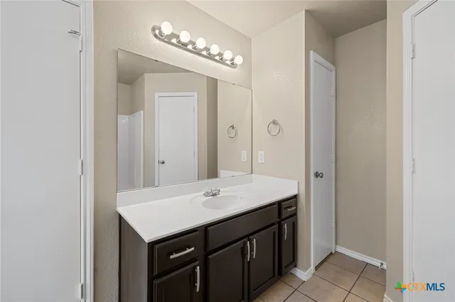 a bathroom with a bathtub sink and mirror