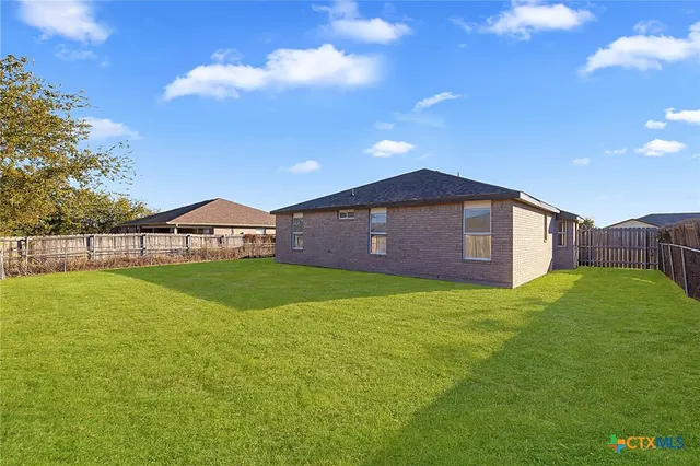 a view of a big yard with large trees