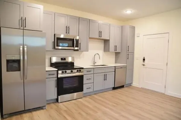 a kitchen with a sink stove and refrigerator
