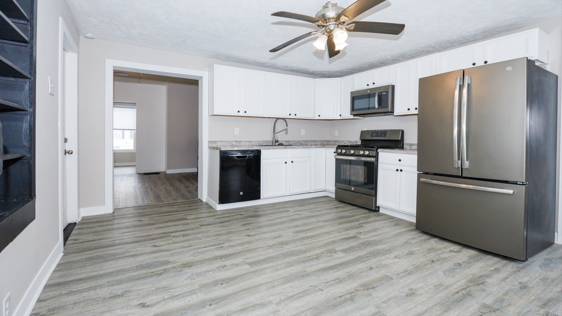 300 East South Street Atlanta, IL 61723 - Photo 12 of 69 a kitchen with stainless steel appliances hardwood floor sink and refrigerator