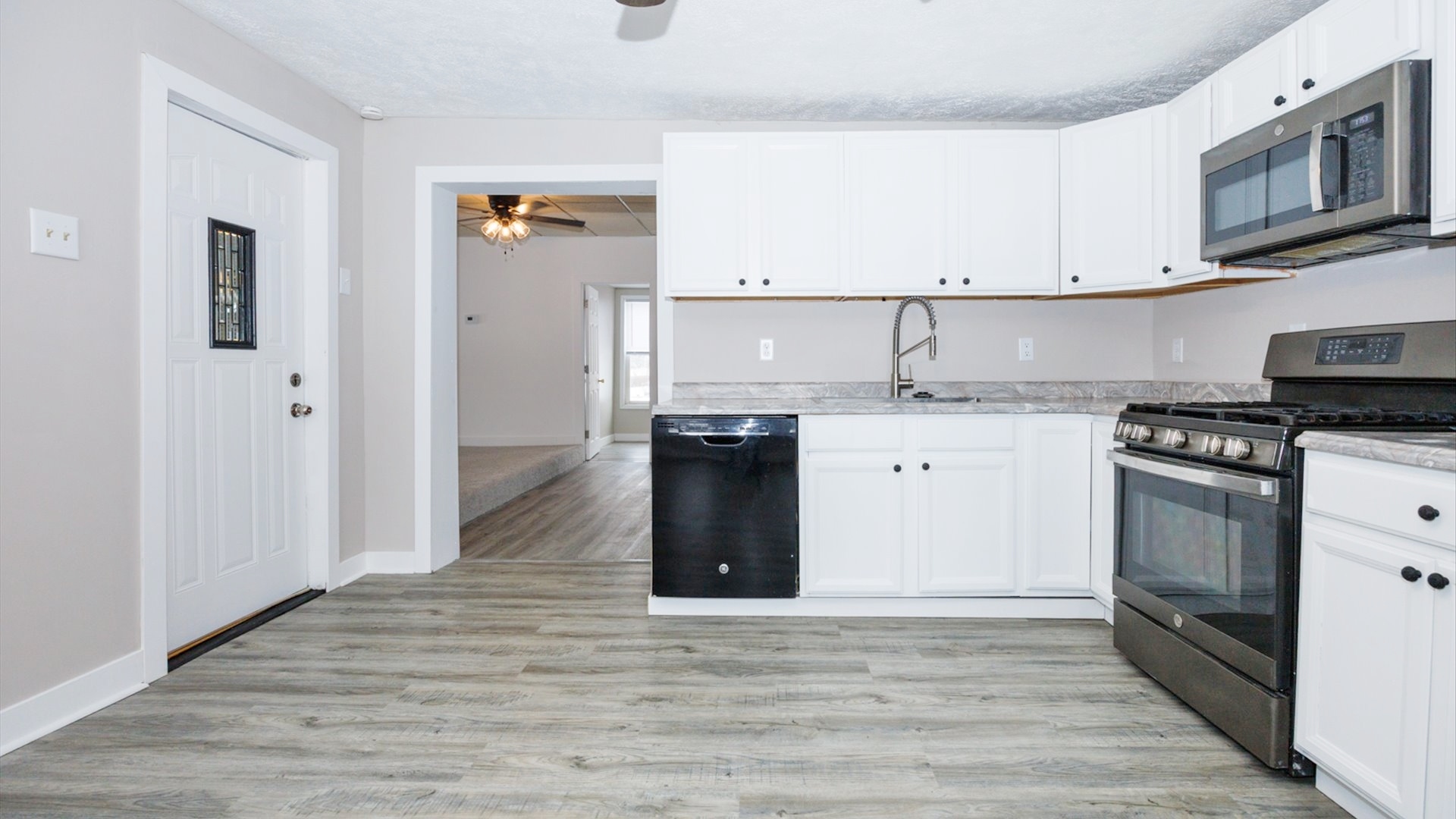 300 East South Street Atlanta, IL 61723 - Photo 17 of 69 a kitchen with stainless steel appliances granite countertop a stove a sink and a microwave