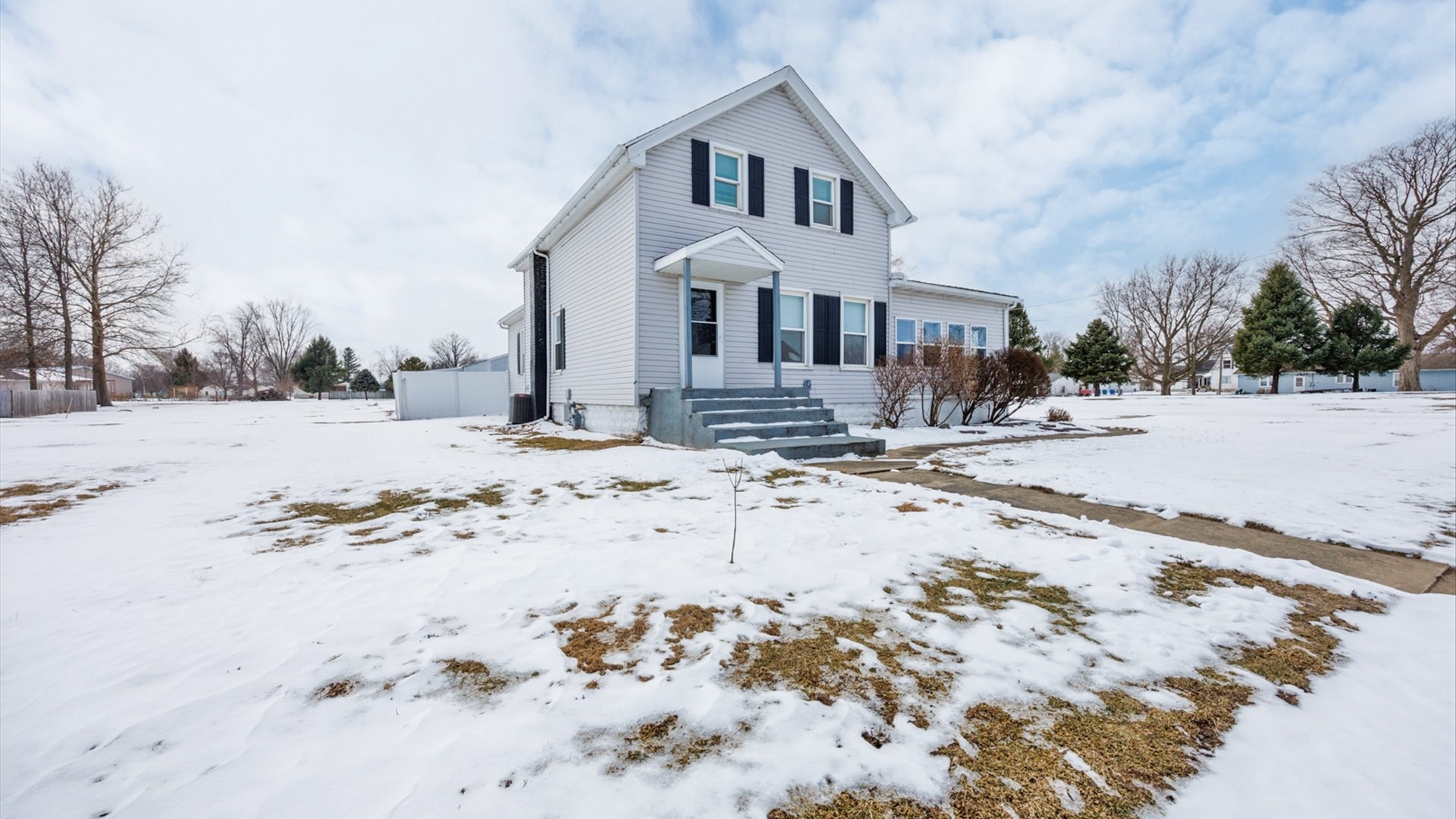 300 East South Street Atlanta, IL 61723 - Photo 56 of 69 a view of white house with a yard covered in snow
