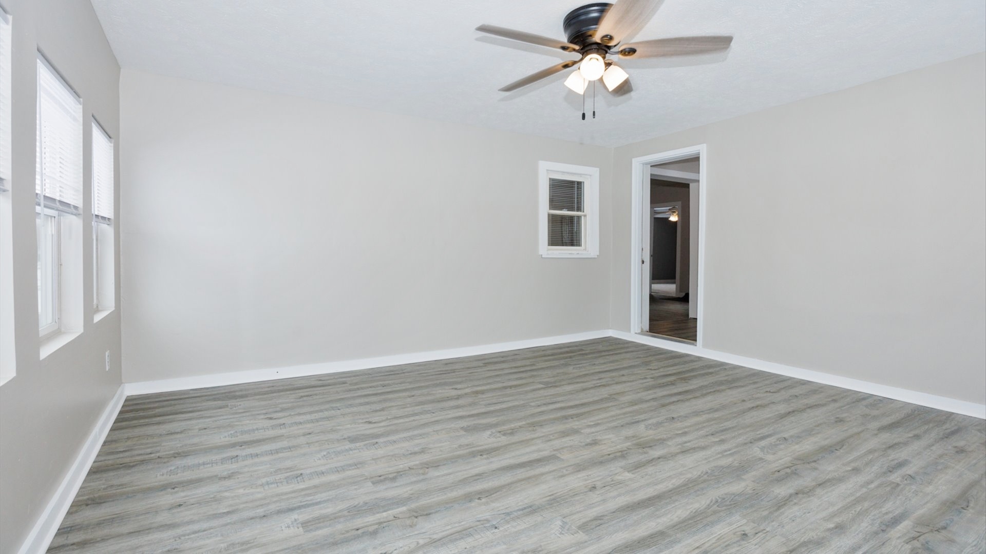 300 East South Street Atlanta, IL 61723 - Photo 9 of 69 wooden floor in an empty room with a window