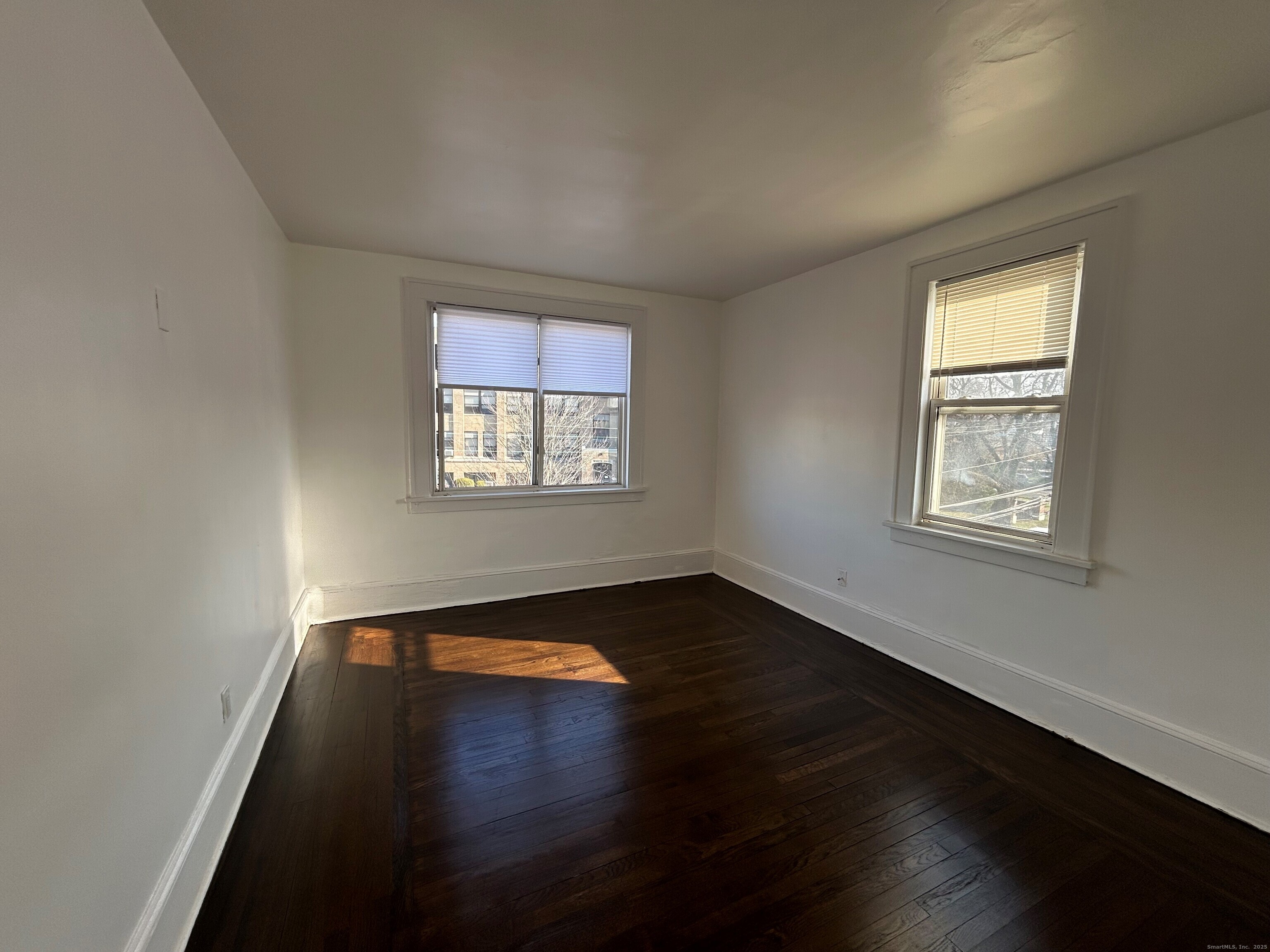 4 5th Avenue, Unit 7 Danbury, CT 06810 - Photo 2 of 3 a view of an empty room with wooden floor and a window