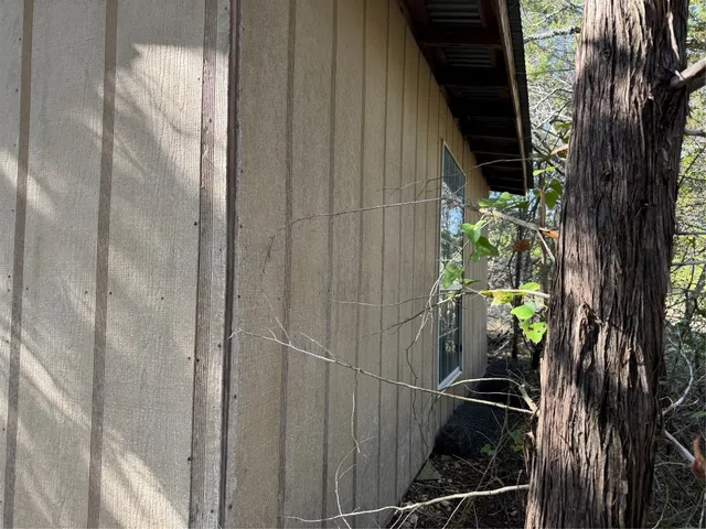 a view of a yard with large trees