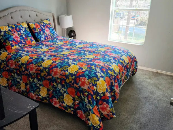 a bed sitting in a bedroom next to a window