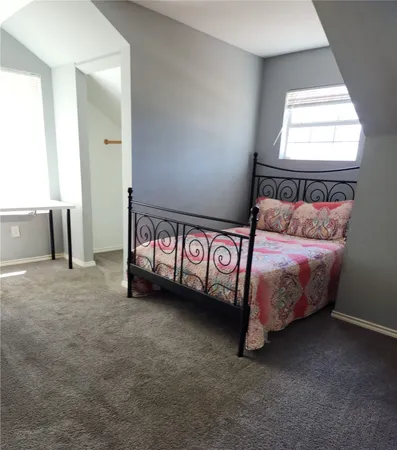 a bed room with a bed and a window