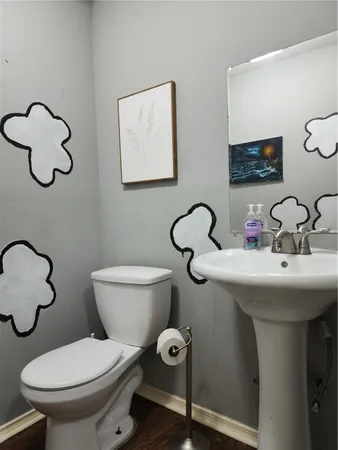 a bathroom with a toilet sink and mirror
