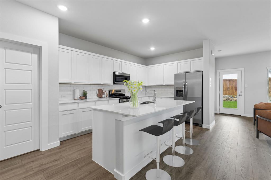 1428 Companero Street Haslet, TX 76052 - Photo 6 of 33 Kitchen in the Oscar home plan by Trophy Signature Homes – REPRESENTATIVE PHOTO