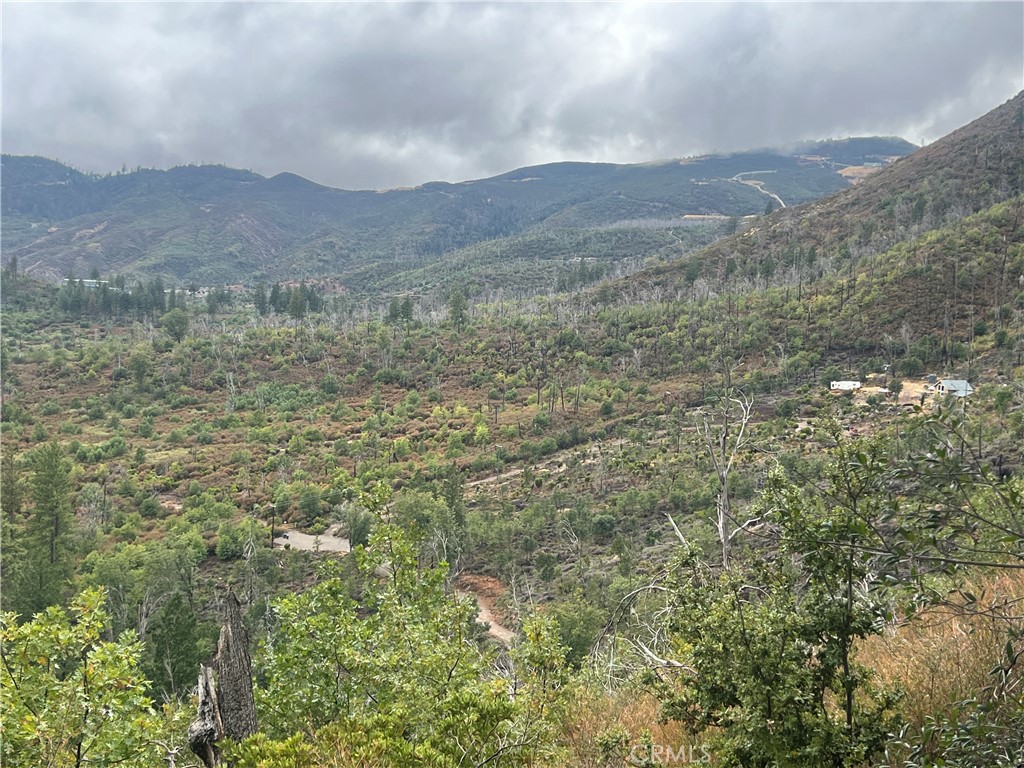 17655 Ford Flat Road Middletown, CA 95461 - Photo 6 of 15 a view of a dry yard with mountains in the background