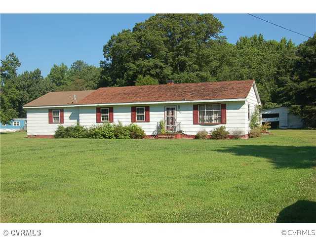 190 Weems Road Weems, VA 22576 - Photo 1 of 1 a front view of a house with a yard