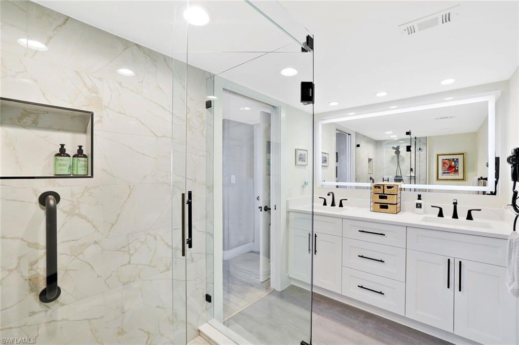 17 Bluebill Avenue, Unit 206 Naples, FL 34108 - Photo 20 of 30 Full bathroom featuring double vanity, a marble finish shower, and recessed lighting