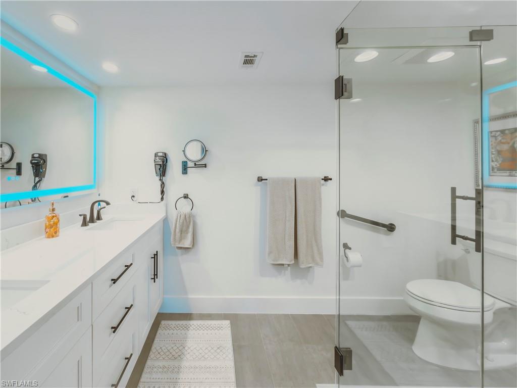 17 Bluebill Avenue, Unit 206 Naples, FL 34108 - Photo 21 of 44 a bathroom with a sink a toilet and shower