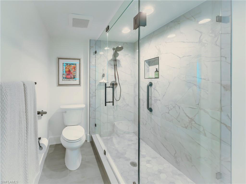 17 Bluebill Avenue, Unit 206 Naples, FL 34108 - Photo 22 of 44 a bathroom with a toilet and a shower