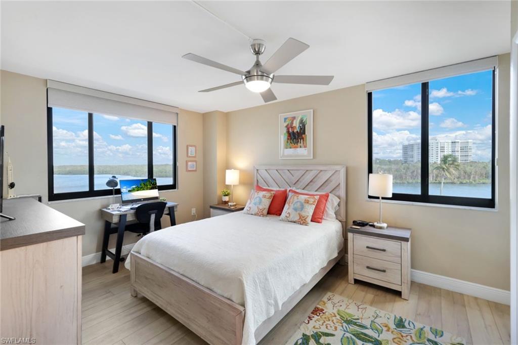 17 Bluebill Avenue, Unit 206 Naples, FL 34108 - Photo 25 of 44 a bedroom with a bed and large windows