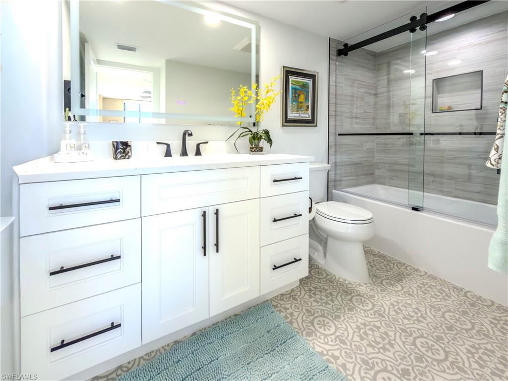 17 Bluebill Avenue, Unit 206 Naples, FL 34108 - Photo 27 of 44 a bathroom with a sink toilet a mirror and shower