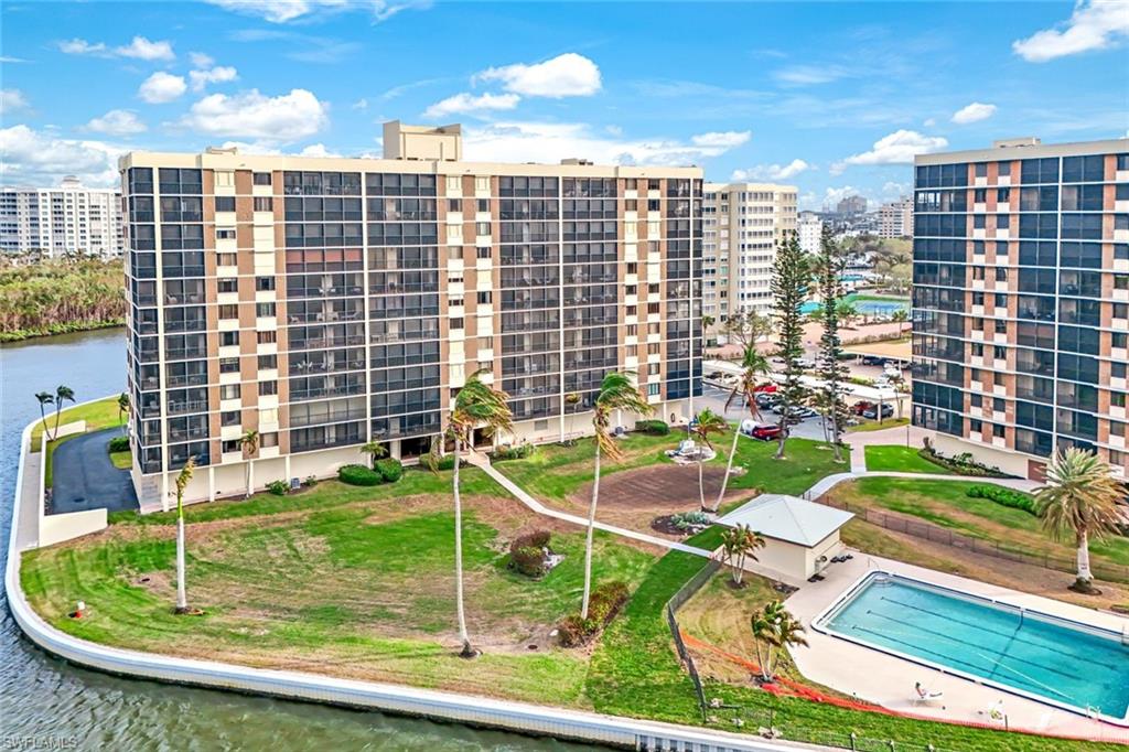 17 Bluebill Avenue, Unit 206 Naples, FL 34108 - Photo 27 of 30 View of apartment building / complex featuring a community pool and a water view