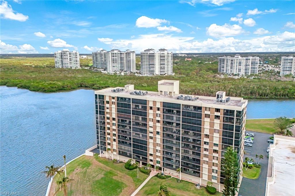 17 Bluebill Avenue, Unit 206 Naples, FL 34108 - Photo 29 of 30 Aerial view of a large body of water and apartment complex