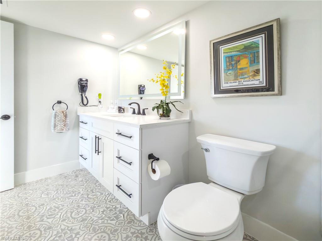 17 Bluebill Avenue, Unit 206 Naples, FL 34108 - Photo 30 of 44 a white toilet sitting next to a bathroom sink