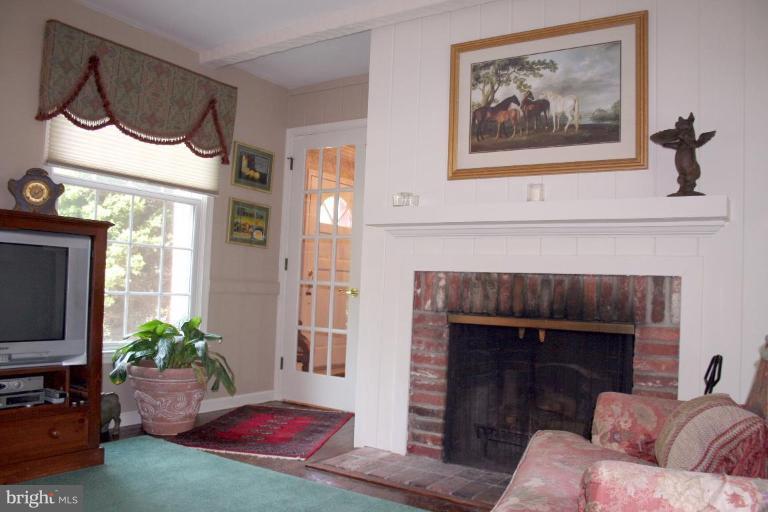 13703 Harcum Road Phoenix, MD 21131 - Photo 15 of 20 a living room with furniture and a fireplace