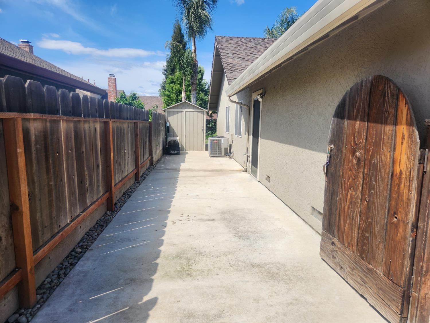 777 Jordanolo Drive Ripon, CA 95366 - Photo 52 of 61 a view of a pathway of a house with wooden fence