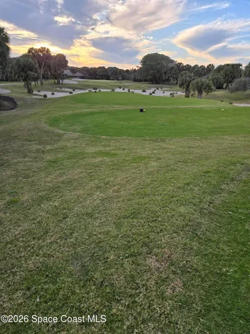 a view of a green field with clear sky