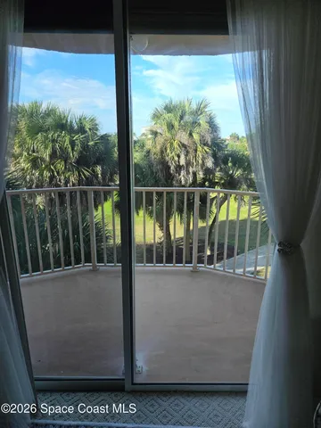 a view of a balcony next to a yard