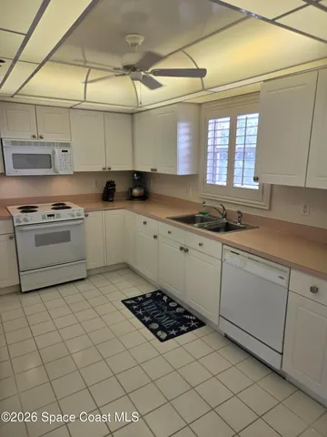 a kitchen with a sink a stove and cabinets