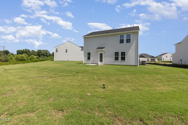 a house view with swimming pool in front of it