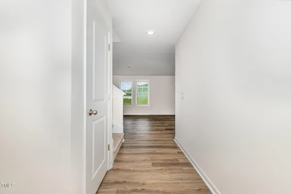 a view of a hallway with wooden floor