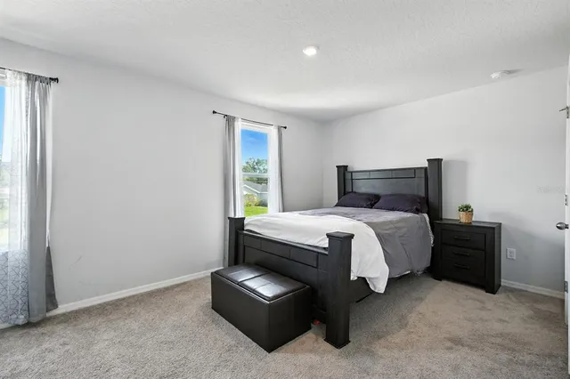 a bed sitting in a room next to a window