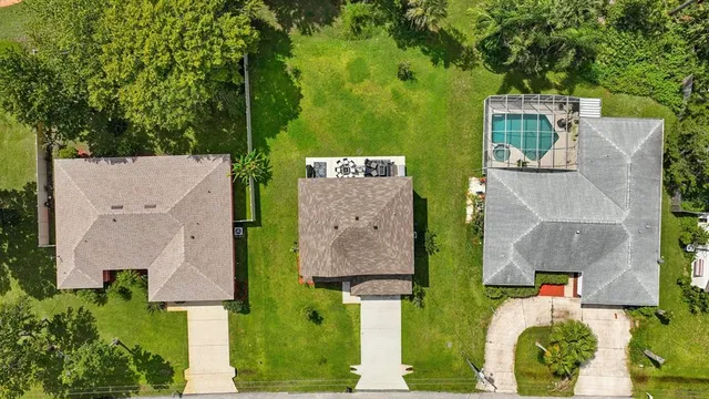 an aerial view of a house with garden space and street view