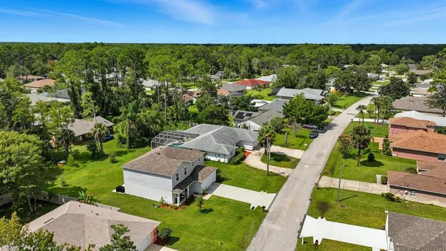 an aerial view of a house with garden space and street view