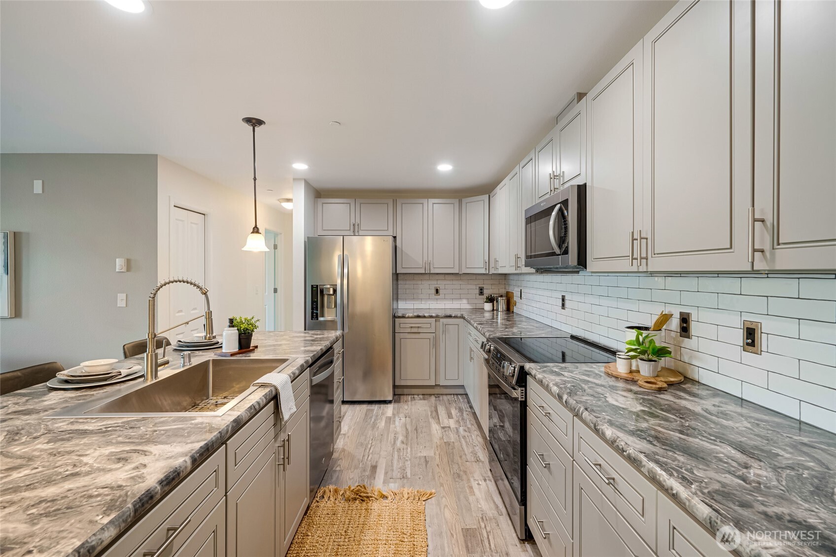 4678 Wade Street, Unit 201 Bellingham, WA 98226 - Photo 8 of 25 a kitchen with granite countertop a sink stainless steel appliances and cabinets