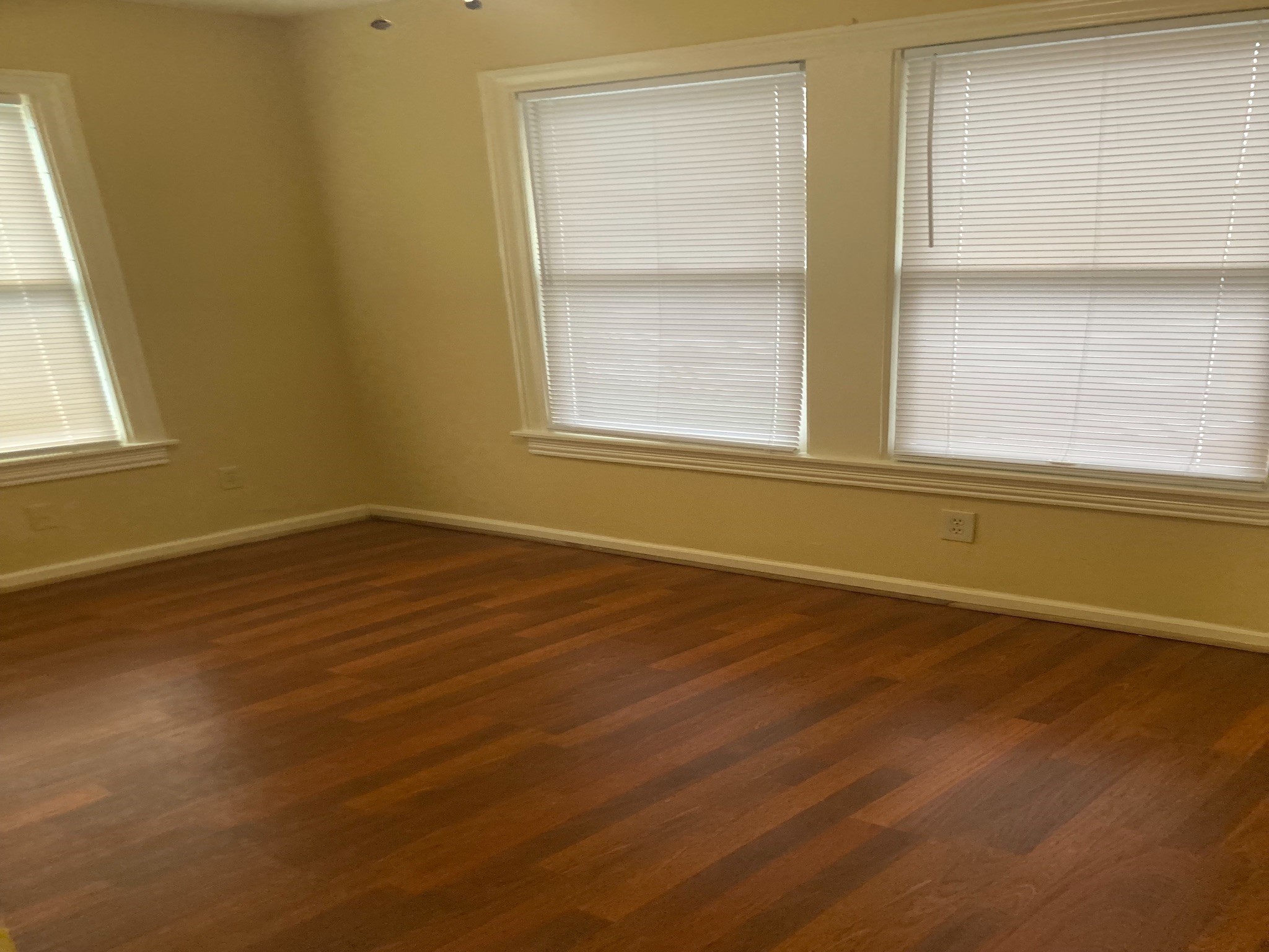 4921 Maxie Street, Unit 1/2 Houston, TX 77007 - Photo 11 of 14 an empty room with wooden floor and windows
