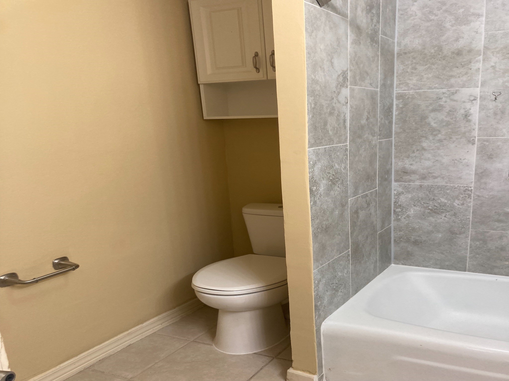 4921 Maxie Street, Unit 1/2 Houston, TX 77007 - Photo 13 of 14 a white toilet sitting next to a bath tub