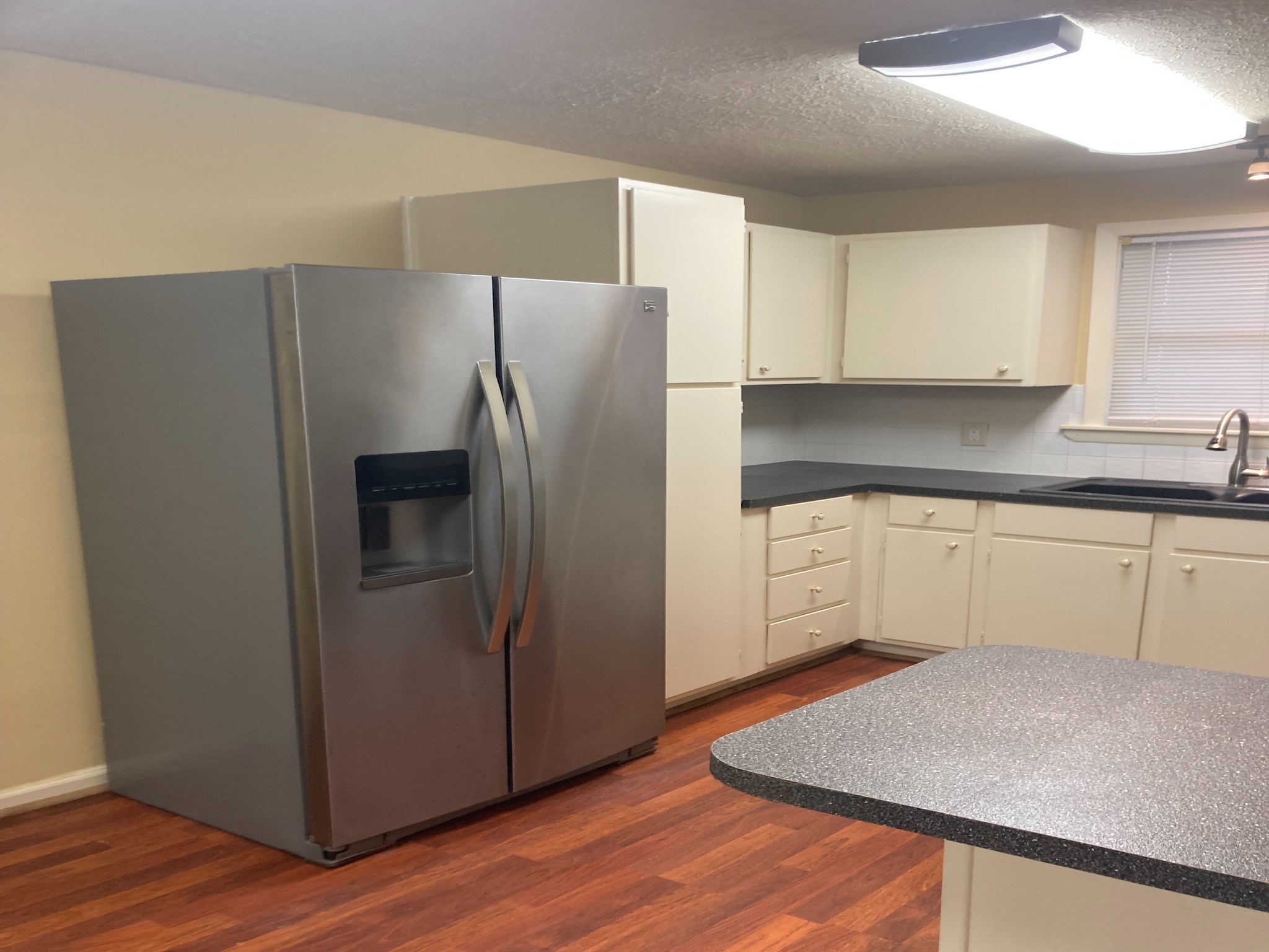 4921 Maxie Street, Unit 1/2 Houston, TX 77007 - Photo 3 of 14 a kitchen with a refrigerator sink and cabinets