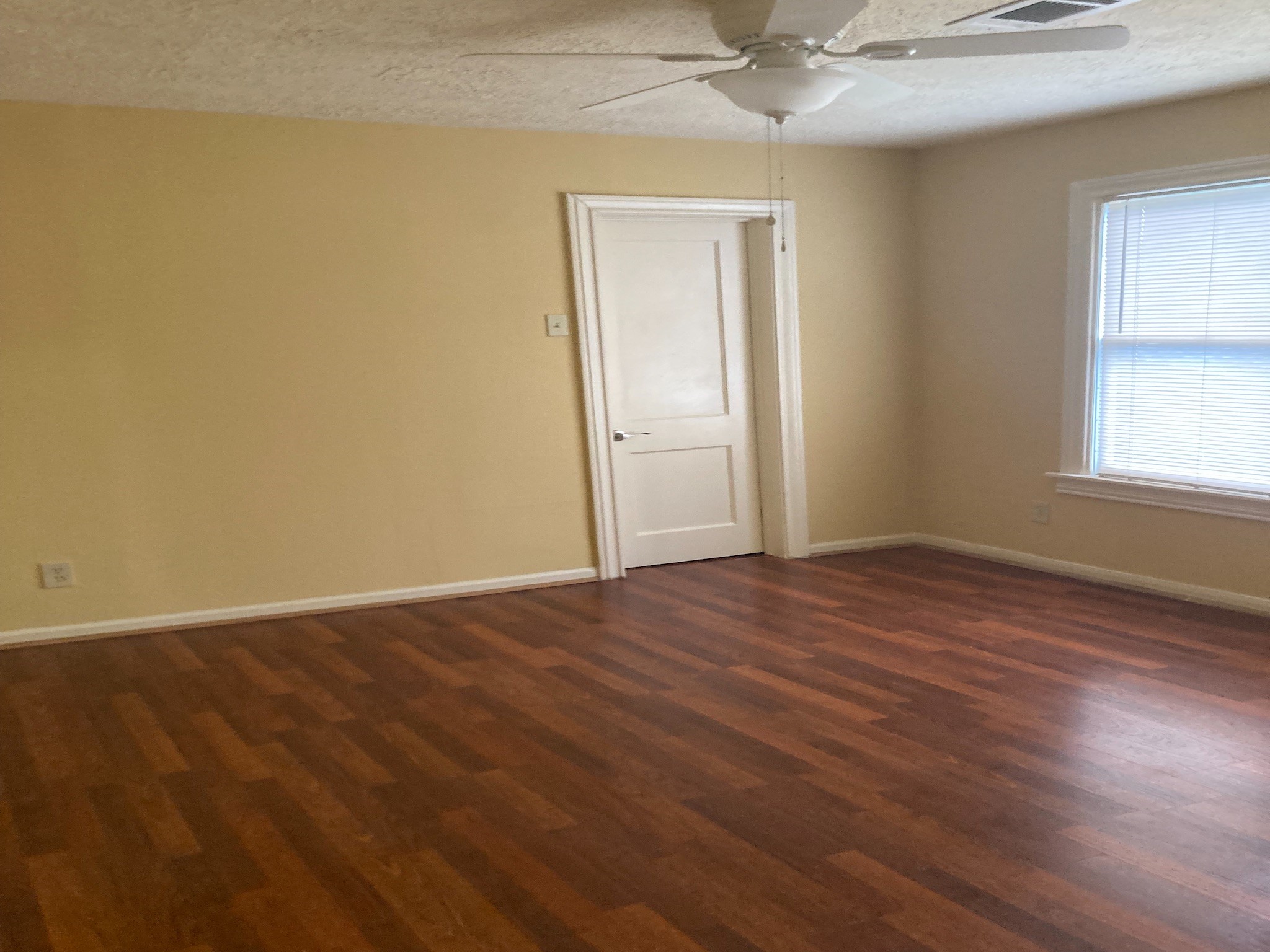 4921 Maxie Street, Unit 1/2 Houston, TX 77007 - Photo 9 of 14 an empty room with wooden floor and windows