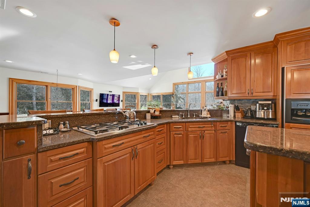 285 Chestnut Ridge Road Woodcliff Lake, NJ 07677 - Photo 21 of 46 a kitchen with stainless steel appliances granite countertop a sink a stove and a refrigerator