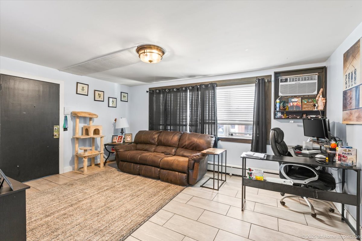 7110 West 107th Street, Unit 16 Worth, IL 60482 - Photo 3 of 12 a living room with furniture and a flat screen tv