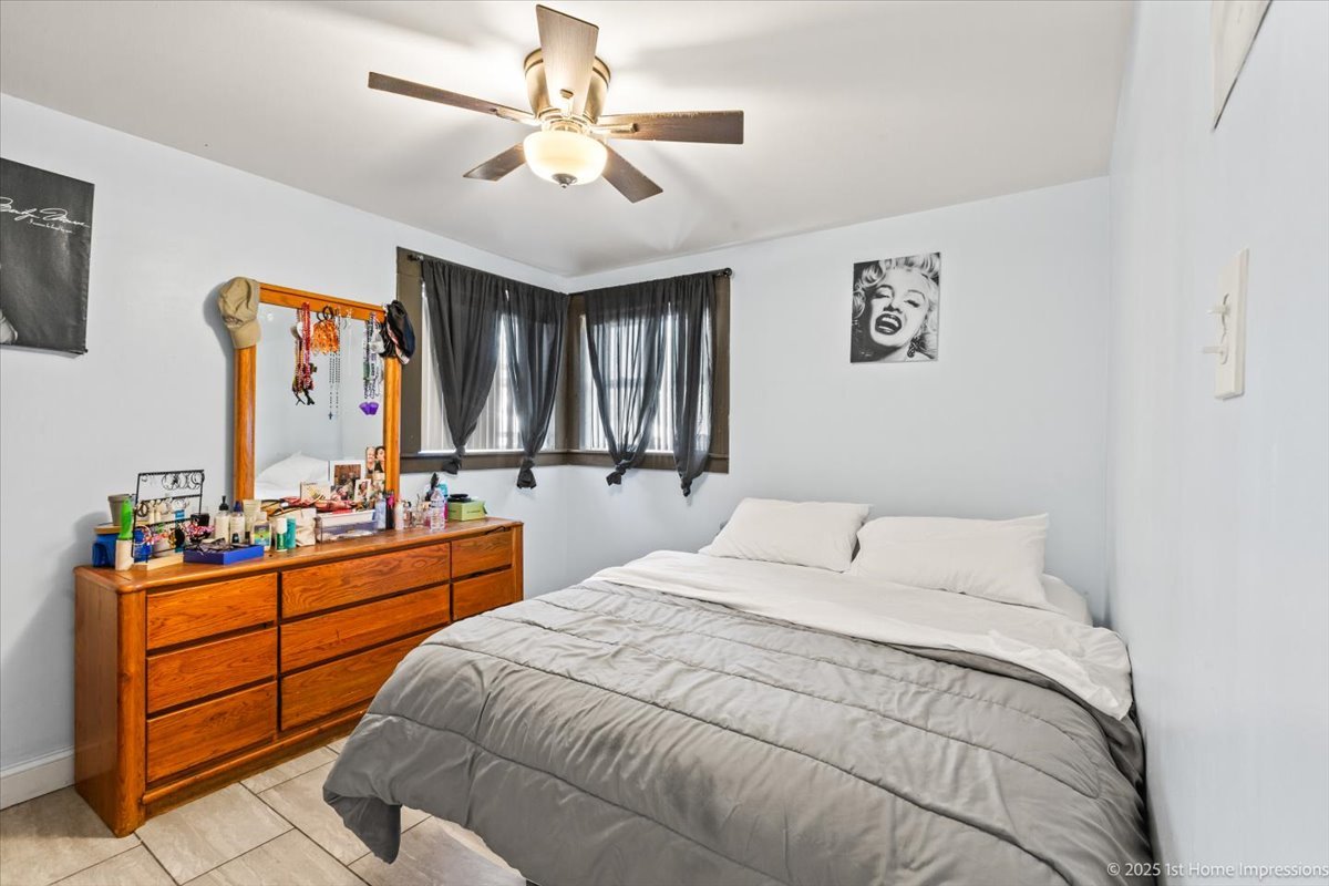7110 West 107th Street, Unit 16 Worth, IL 60482 - Photo 5 of 12 a bedroom with a large bed and a chandelier